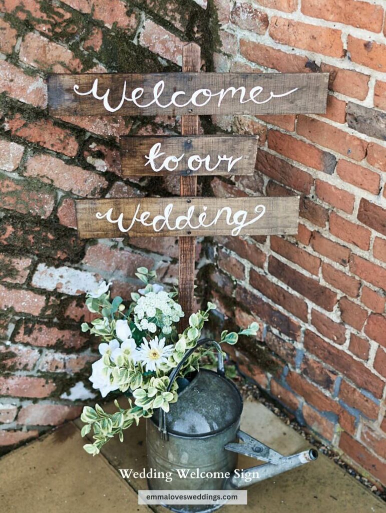 Rustic wedding welcome sign made of wood inscribed with "welcome to our wedding"