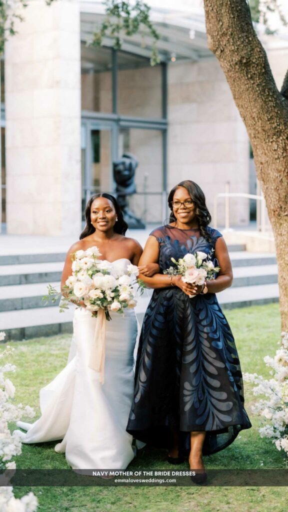 She accompanied her daughter down the aisle in a navy mother of the bride dress with floral accents.