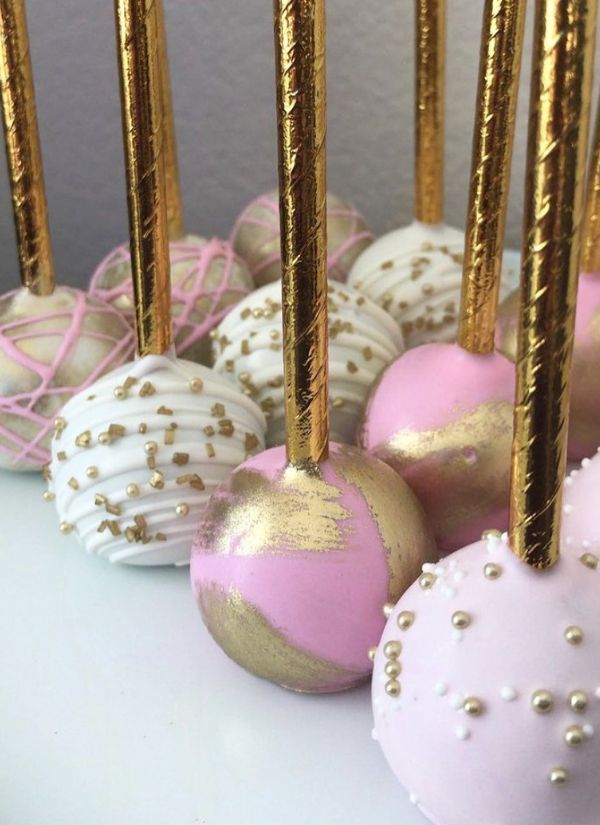 These pink and gold cake pops with an Oreo truffle are perfect for a wedding.