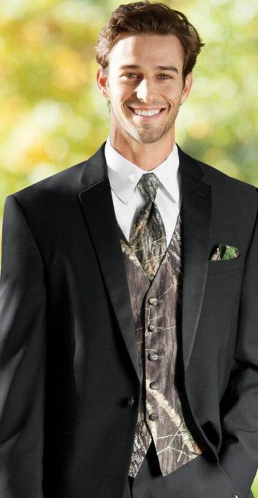 For the groom a mossy oak camo vest is the perfect complement to his black tuxedo.