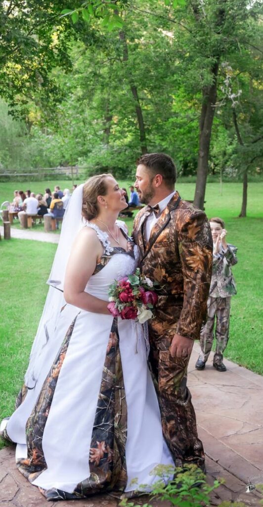 This camo wedding dress for bride and groom is perfect for a rustic or country themed outdoor wedding or reception.