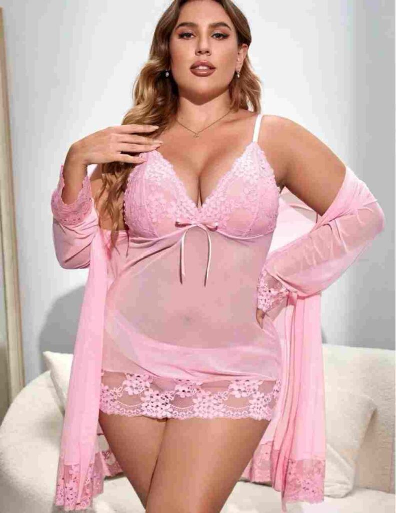 You'll never want to take off this stylish baby doll until you do. Valentine's Day lingerie for plus size in pink with a belt and a bow of contrast lace.