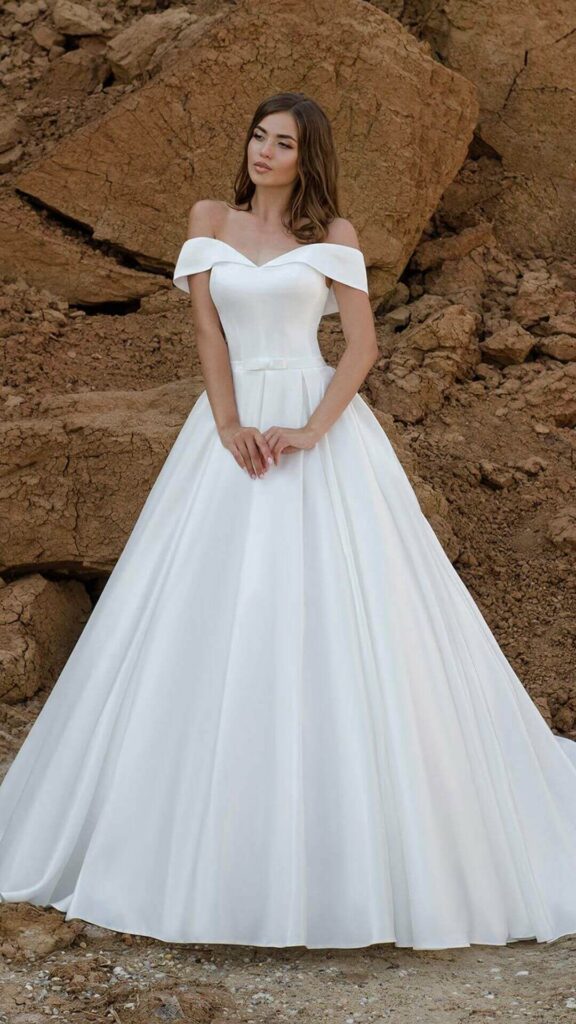 Brides who want to look like princesses on their wedding day should choose this timeless and elegant Off-the-shoulder V-neck A line wedding dress.