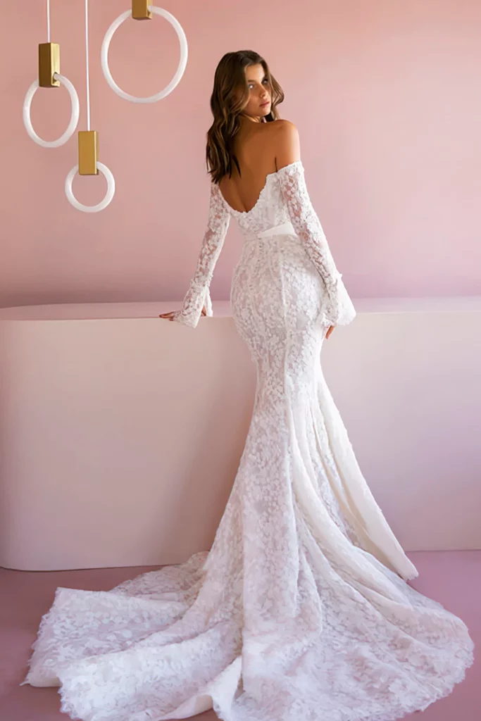 Enhance your sexiness with this white silk ribbon fastened column shaped lace wedding dress with long sleeves that attach to display your bare shoulders.