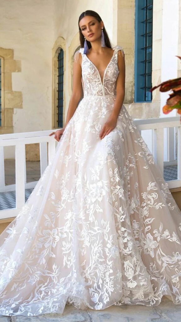 For brides who wish to draw attention to their neckline on their wedding day a V-neck A-line wedding dress with a long train is an excellent idea.