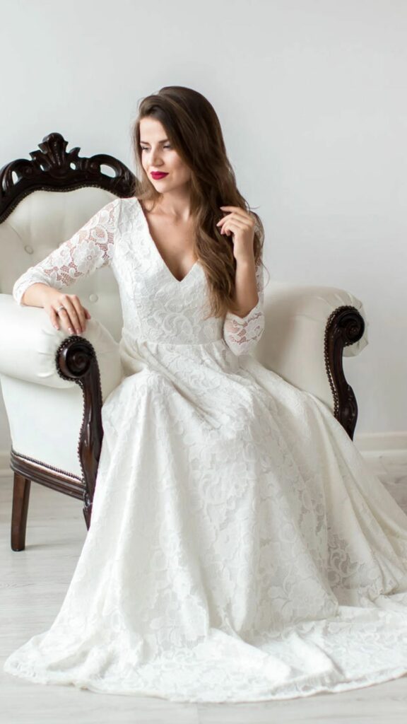 Lovely long wedding dress perfect for the hippie bride this A line features a high neckline long sleeves and a cinched waist.