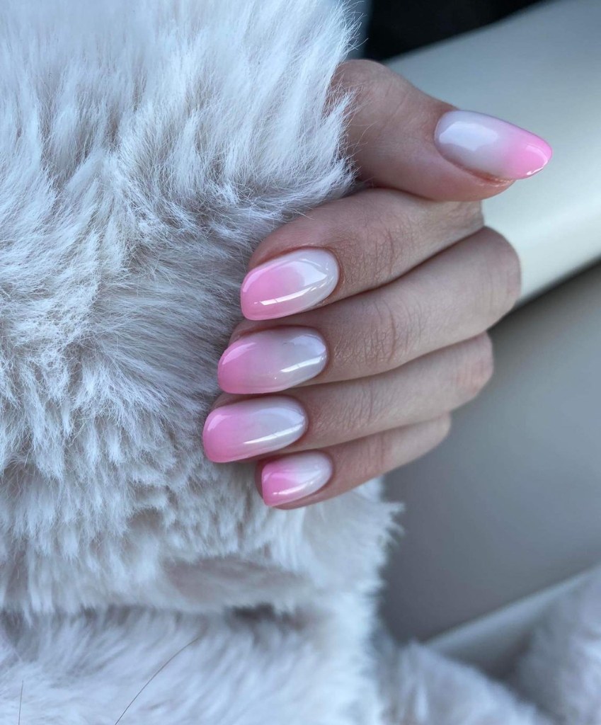 Make a romantic statement on your big day with pink and white ombre nails blending delicate shades for a timeless and elegant look.