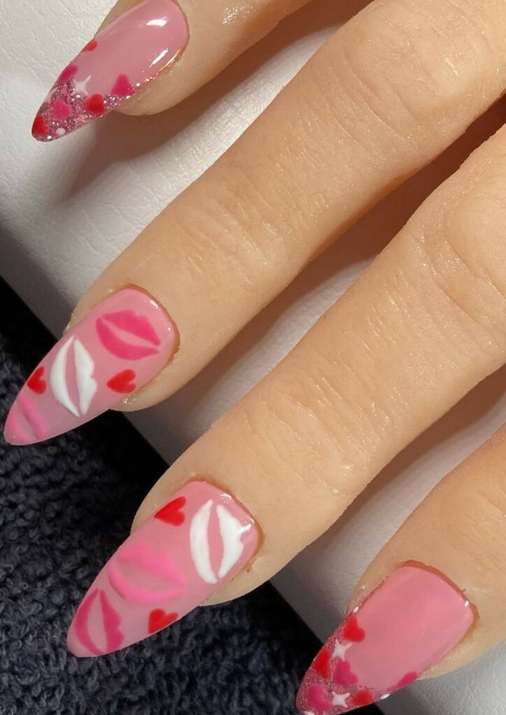 Nail art for Valentines Day painted with pink and white kisses.
