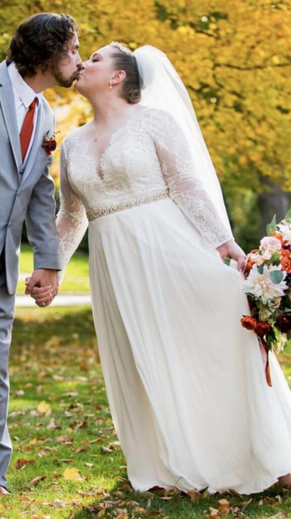 Plus size boho brides can look fabulous in a long sleeve plunge neck A-line wedding dress made of lace trimmed chiffon.
