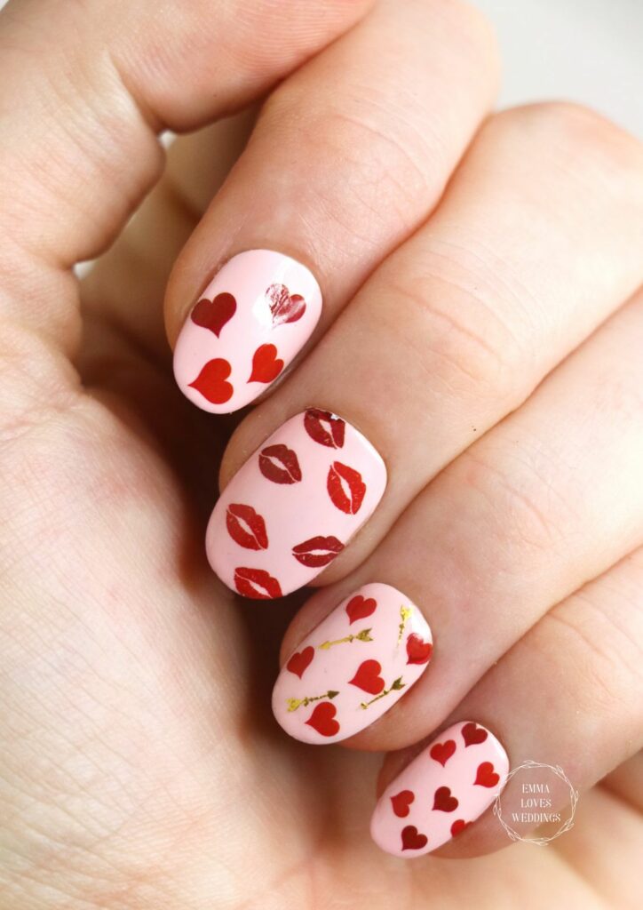 The application of this Valentine's Day-appropriate nail sticker which features a heart, kisses, and an arrow is a cute idea.