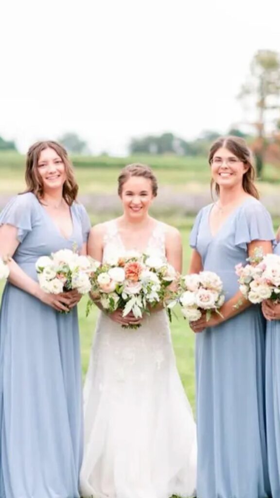The flutter sleeves and dusty blue color of this bridesmaid dress make it unique and special.