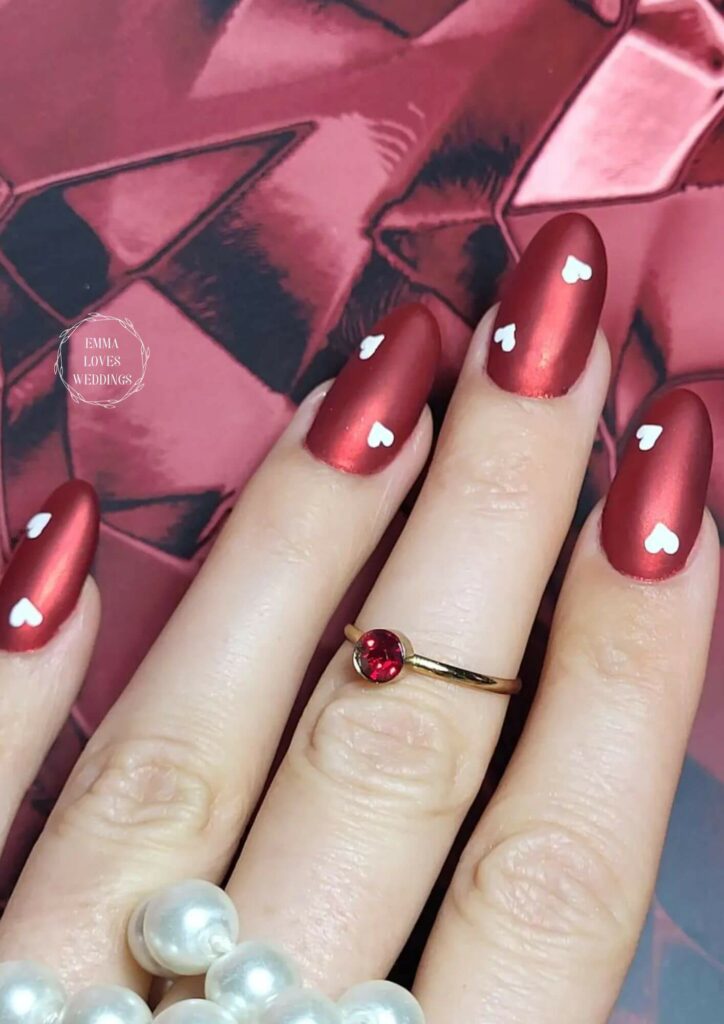 This Valentines Day, try a matte red nail design. Red and matte provide a powerful effect while heart artistry adds elegance.