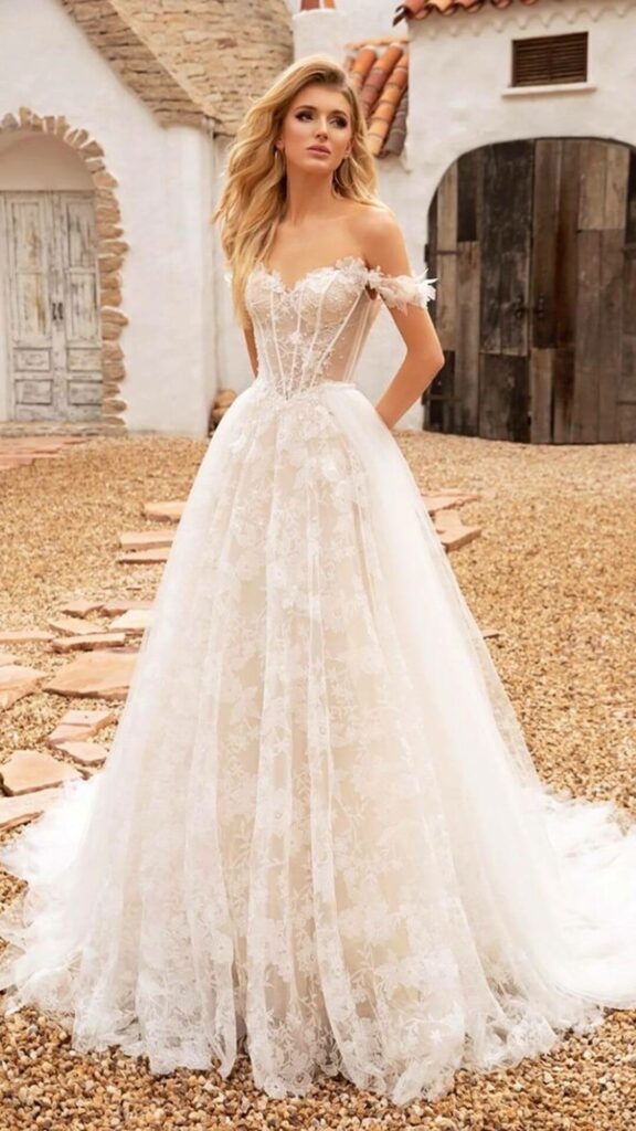 This corset wedding dress is comprised of tulle and has floral lace stretching. The off the shoulder wedding dress is light and simple to move in.