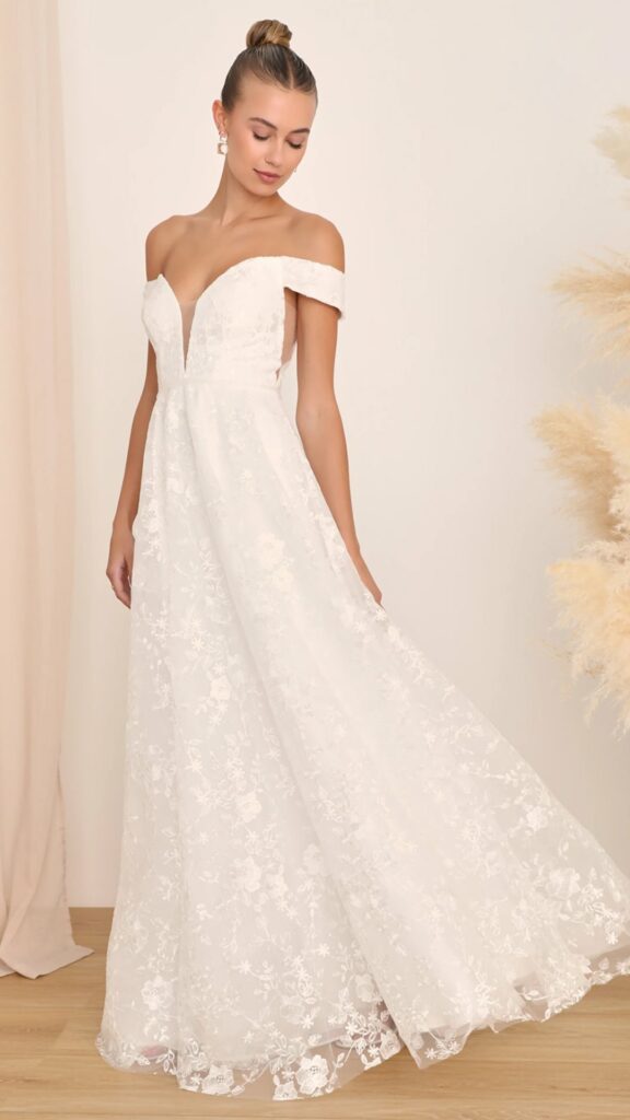 This off-the-shoulder A-line wedding dress with an embroidered tulle overlay and a sequined tulle lining is all you need now that you've found the one.