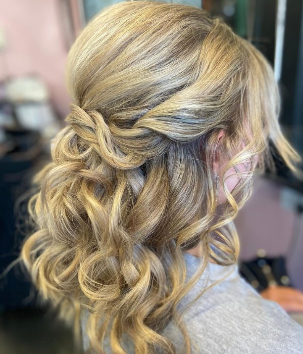 A chic wedding hairstyle idea is to curl your medium length hair and wear it half up