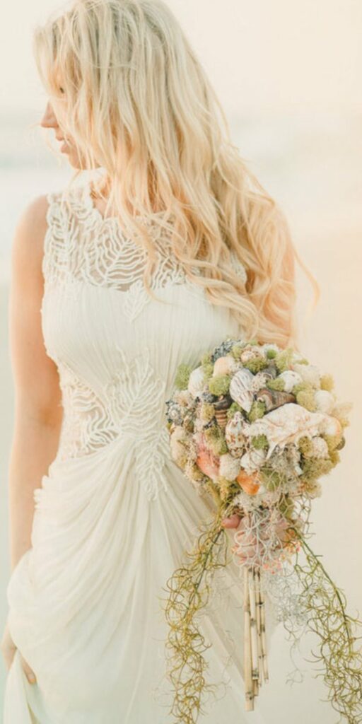A flowing wedding dress and bouquet are the perfect pair for a dreamy beach wedding day