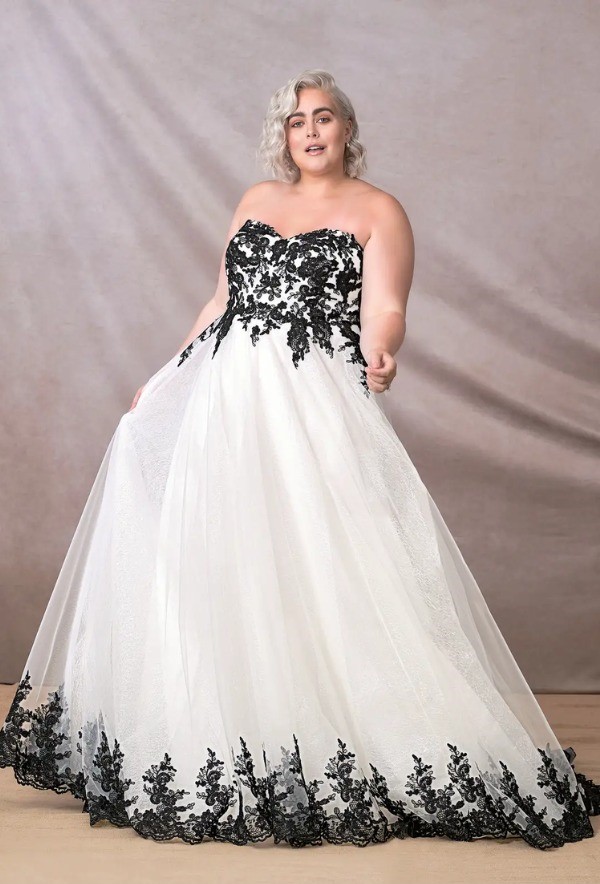 A stylish idea for the plus size bride is a black and white ball gown with a sweetheart neckline and a chapel train.