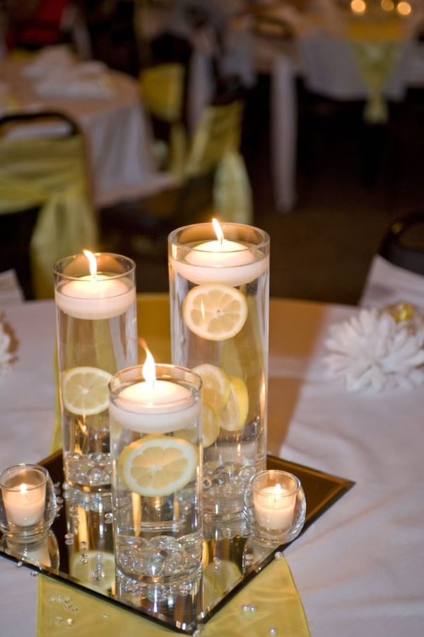 Adding lemon slices to a floating candle for a wedding centerpiece is a stylish touch.