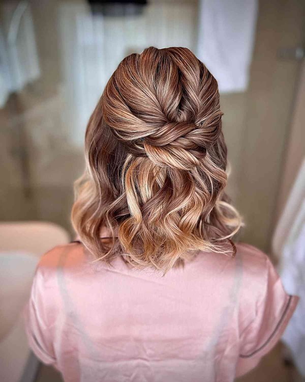An elegant way to highlight your waves and volume in your short blunt wedding hair is with a half up braid.