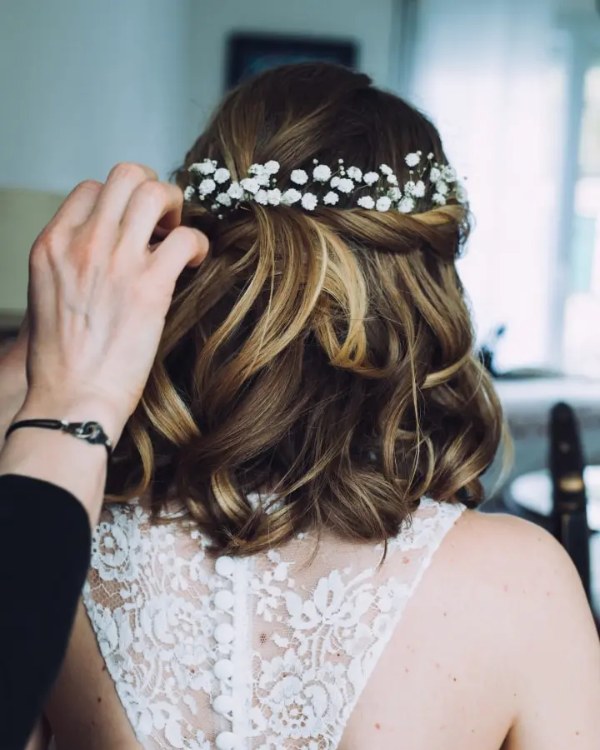 Beautiful brides with shorter hair who don't have enough for a complete bun but want some extra texture to their look can try this half-up wedding hairstyle.