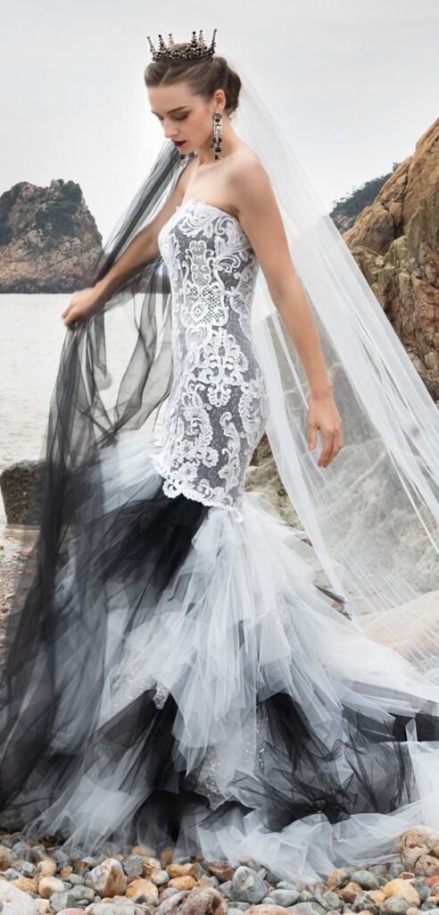 Black and white gothic wedding dress with embroidered lace overlay ideal for a beach wedding.