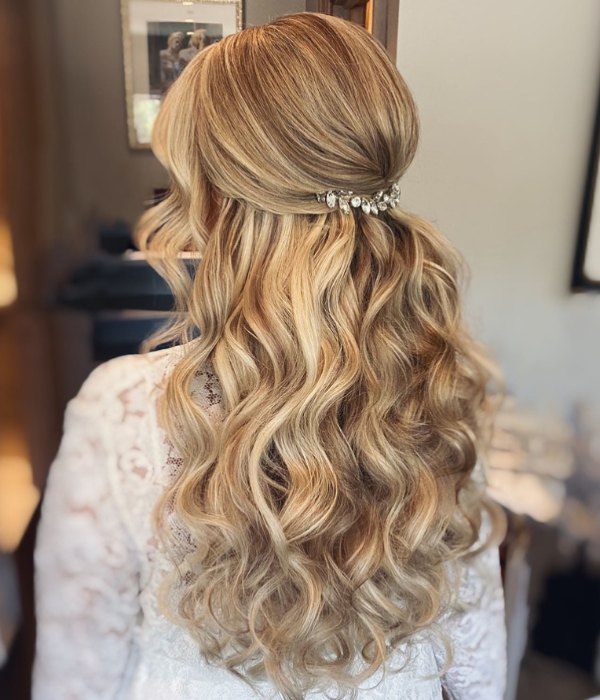 Create a stunning bridal look with a half up half down hairstyle for long hair adorned with delicate hair accessories such as a sparkly hairpin or a floral hair vine