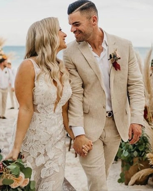 Effortlessly embodying the essence of beachside charm a beige linen suit is the perfect choice for a groom seeking a timeless and relaxed wedding day look