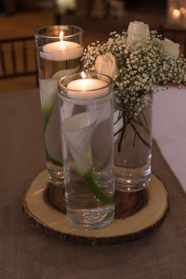 Elevate your centerpiece game by submerging floral arrangements in water and accentuating them with a mesmerizing floating candle leaving your guests in awe.