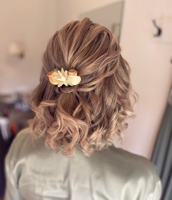 Flower adorned half up wedding hairstyles for short hair are stunning.