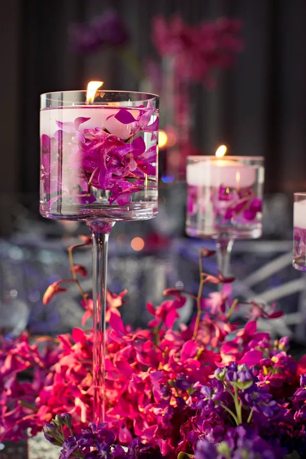 Make a bold statement at your purple themed wedding with a stunning plum floating candle centerpiece embellished with a touch of silver adding a touch of glamor and elegance