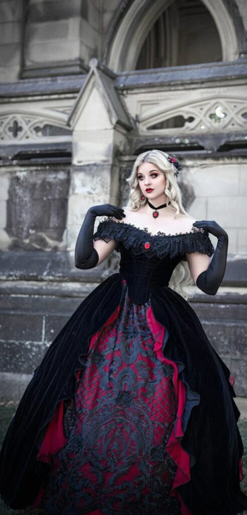 Off the shoulder vampire bridal gown in Gothic Victorian style made of lightweight black velvet with dark red.