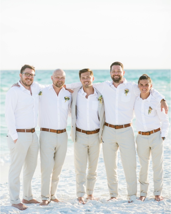 The groom can feel the sand between his toes and the wind in his hair while wearing the ideal blend of casual and sexy beach wedding attire.