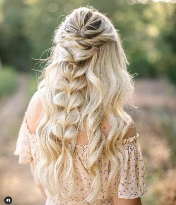 The half-up wedding hairstyle can be customized to suit any bride's taste whether its a sleek and modern look or a more bohemian and relaxed vibe