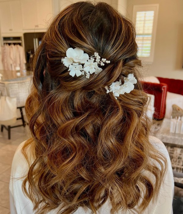 The ideal hairstyle for a bride on her wedding day is a medium length half up do with hair accessories.