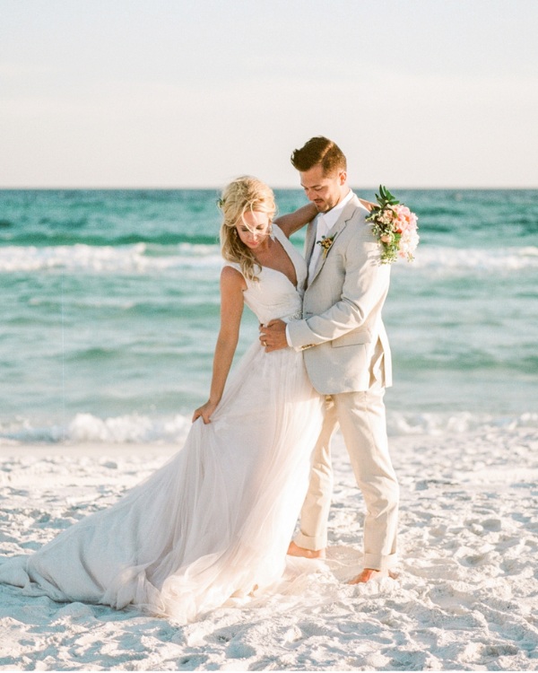 The sand between his toes and a suit make for the perfect beach wedding attire for the groom.