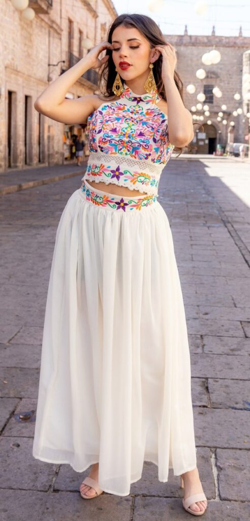 This beautiful Mexican wedding dress has a floral embroidered top and a chiffon skirt.
