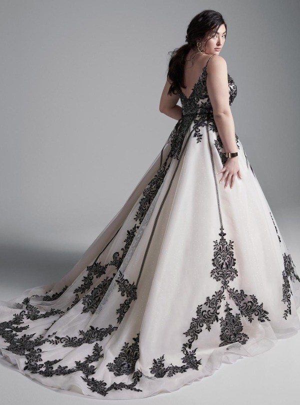 This black and white plus size relaxed ball gown with soft lace embellishments highlights your bodice while a sweeping train creates a long graceful silhouette.