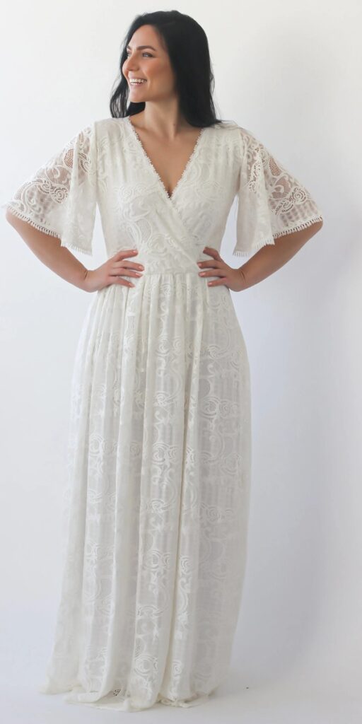 This boho inspired plus size beach wedding dress features billowy puff sleeves for a dreamy romantic look