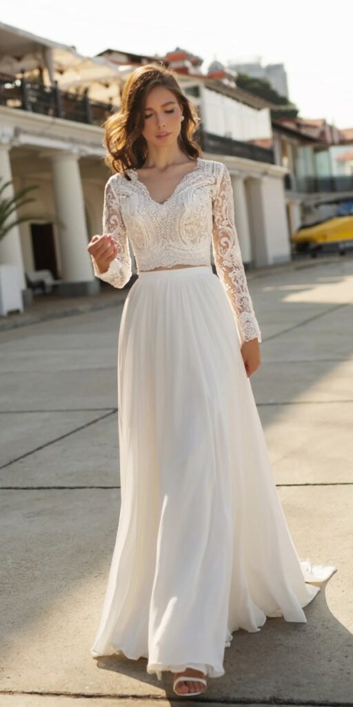 This fit lace crop top casual beach wedding dress with a chiffon flowy skirt can be a perfect choice for brides who value simplicity and ease.