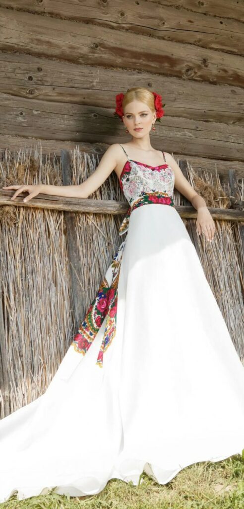 This long folk style Mexican bridal dress is a boho brides dream in a vivid palette of red green and satin.