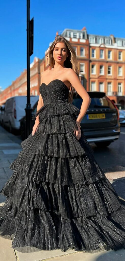 This strapless black wedding dress has a fitted bodice and a full flared skirt a modern take on the classic ball gown silhouette.
