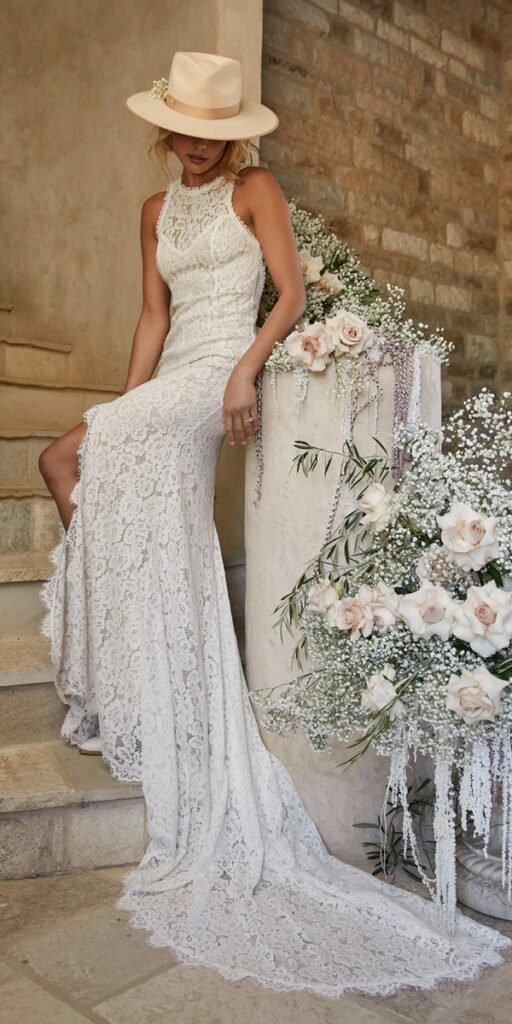 This stunning boho beach wedding dress is made of sheer flowery lace that is ideal for outdoor summer weddings.