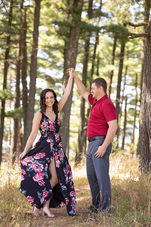 A stunning flower design black maxi dress will add a dash of charm to your engagement picture