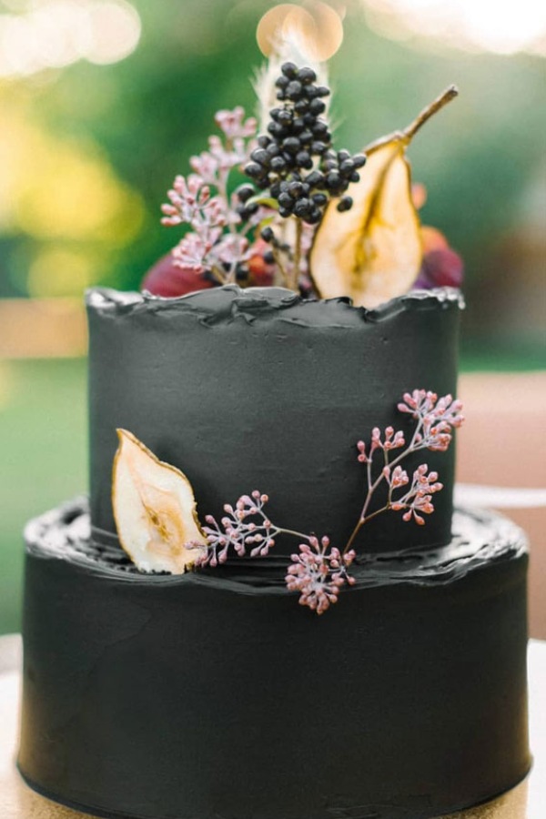 Black Buttercream wedding cake topped with colorful fruits
