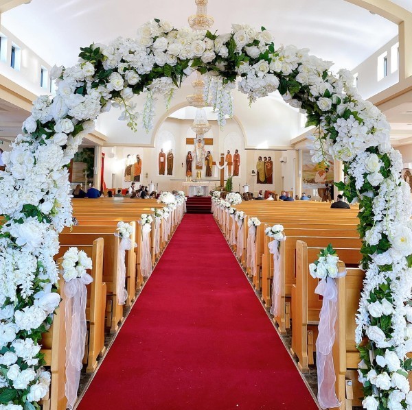 Elegant white and green church aisle decoration ideas with red wedding runner