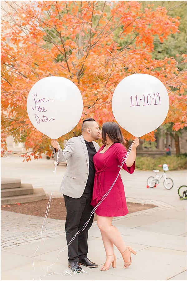 Engagement photos in the fall with colorful balloons and a wedding date are a great idea