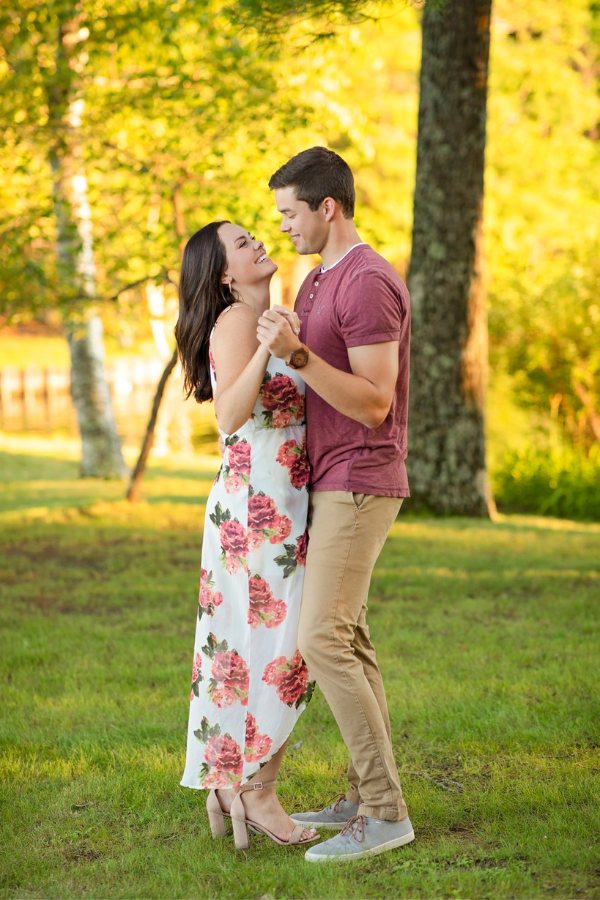 Enjoy the one you love while taking engagement photos in a beautiful floral dress
