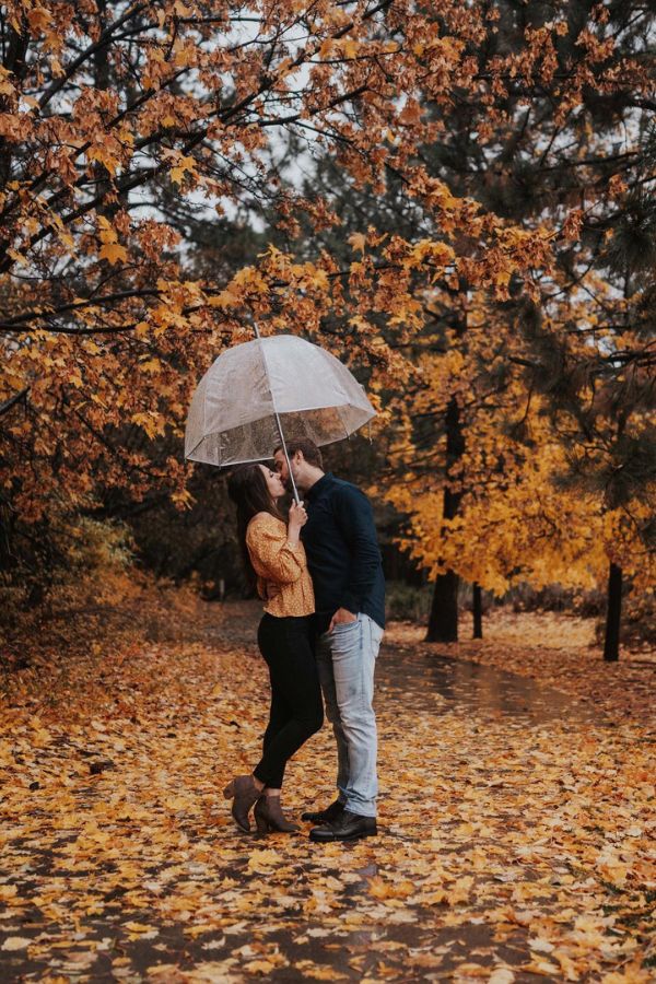 For their engagement shot the couple used an umbrella to enjoy the rain