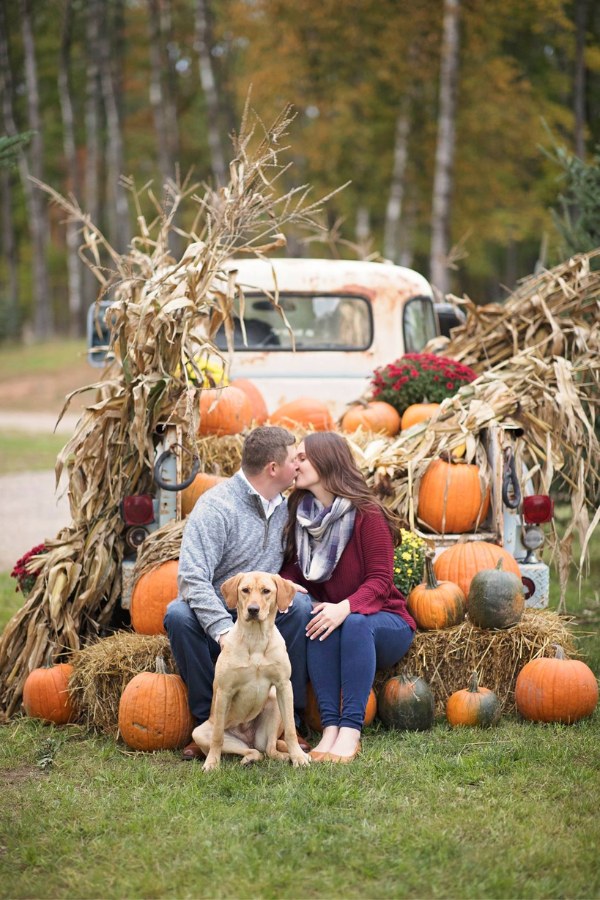 Including your dog in a photo session around the pumpkin centerpiece is a great idea