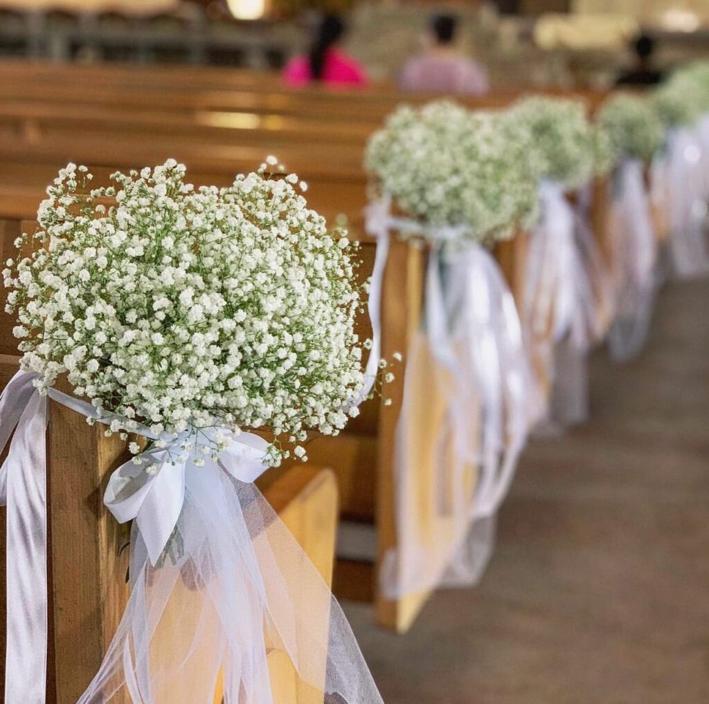 Simple and elegant church pew wedding decorations with baby's breath